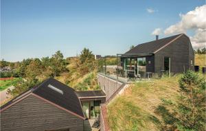 a house on top of a hill with a house at Nice Home In Blokhus With 4 Bedrooms, Sauna And Wifi in Blokhus