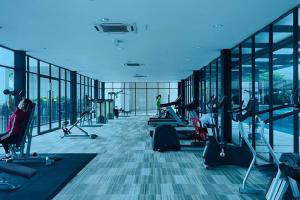 an empty gym with people exercising on tread machines at D'puncak Trefoil Setia Alam in Setia Alam
