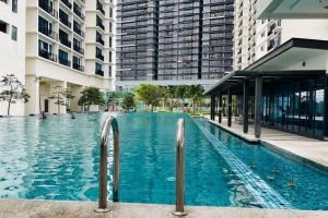 a large swimming pool in a city with tall buildings at D'puncak Trefoil Setia Alam in Setia Alam