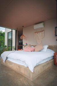 a bedroom with a large bed in a room at Amanatu Ecolodge & Spa in Quimbaya