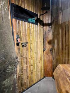 a room with a wooden wall with a door at Amanatu Ecolodge & Spa in Quimbaya