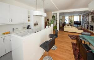 a kitchen and living room with white cabinets and a bar at Holiday-business Residence in Taufkirchen