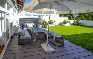 a patio with a table and chairs and an umbrella at Holiday-business Residence in Taufkirchen