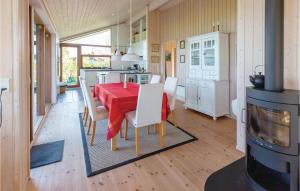a kitchen and dining room with a red table and chairs at Gorgeous Home In Nykbing Sj With Kitchen in Ebbeløkke