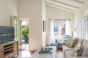 a living room with a couch and a tv at 3795 The Artist's Way apts in Carmel