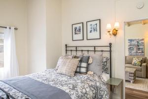 a bedroom with a bed with a blue comforter at 3795 The Artist's Way apts in Carmel