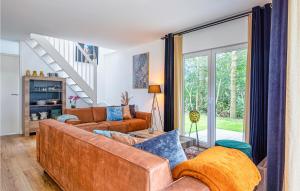 a living room with a couch and a staircase at Wieringen Waddenlodge in Den Oever