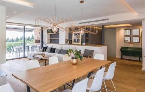 a dining room and living room with a table and chairs at Stunning Home In Alella With Outdoor Swimming Pool in Alella