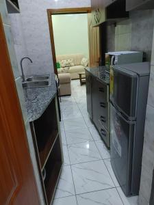 a kitchen with a sink and a counter top at Cozy & Private 1 Bedroom self contained Kigali-Kanombe in Kigali