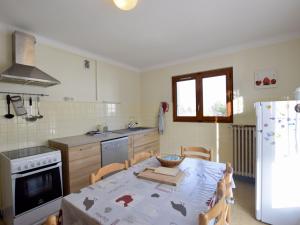 a kitchen with a table and a kitchen with a refrigerator at Appartement Évian-les-Bains, 3 pièces, 5 personnes - FR-1-498-4 in Évian-les-Bains