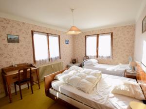 a bedroom with two beds and a desk and a desk at Appartement Évian-les-Bains, 3 pièces, 5 personnes - FR-1-498-4 in Évian-les-Bains