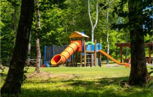 a playground with a slide in a park with trees at 3 Bedroom Beautiful Home In Brestovac in Novo Zvecevo