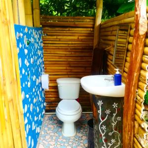 a bathroom with a toilet and a sink at Cabañas Ixaya in Catemaco