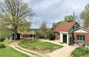 a brick house with a dirt road in front of it at Gorgeous Home In Köpmannebro With Wifi in Köpmannebro