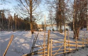 a wooden fence in a snow covered field at Gorgeous Home In Köpmannebro With Wifi in Köpmannebro