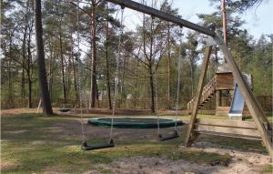 a swing set in a park with a playground at Vossenhol in Ommen