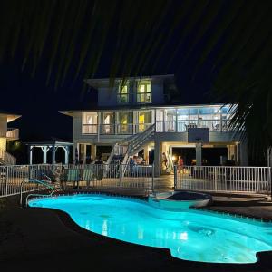 a house with a swimming pool in front of a building at Private Estate Pool Ocean View 20 minutes to Key West in Summerland Key