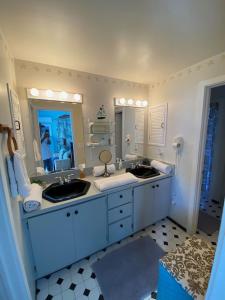 a bathroom with two sinks and a large mirror at Private Estate Pool Ocean View 20 minutes to Key West in Summerland Key