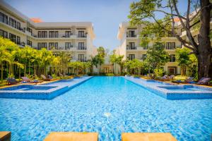a swimming pool in front of a building at Koulen Hotel in Siem Reap