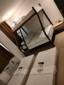 an overhead view of two bunk beds in a room at Hotel Rupert A Baler in Baler