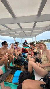 a group of people sitting on the back of a boat at Tipsea Turtle Rooftop Hostel Gili Trawangan in Gili Trawangan