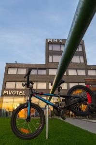 a bike chained to a pole in front of a building at Pivotel MMX in Dobřichovice