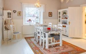 a kitchen with a table and chairs in a room at Stunning home in Segmon with 5 Bedrooms, Sauna and WiFi in Segmon
