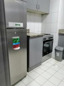 a kitchen with a stainless steel refrigerator and a stove at WN HOMES in Dubai