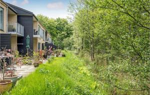 a garden with plants and trees next to a house at Nice Apartment In Hornbk With Wifi in Hornbæk