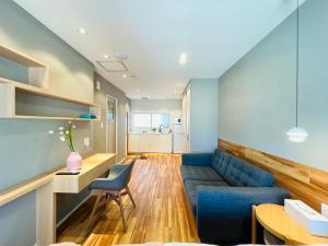 a living room with a blue couch and a table at ZDT in Tokyo