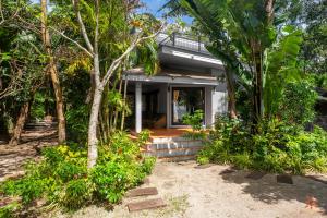 una casa en la playa con árboles y plantas en Sunshine Residence, en Baan Tai