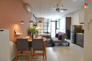 a kitchen and living room with a table and chairs at Lily and Loft - Queensville @ Kuala Lumpur - Netflix in Kuala Lumpur