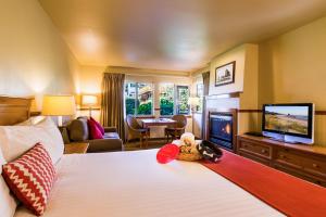 a hotel room with a bed and a television at Inn at Cannon Beach in Cannon Beach