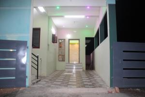 a hallway of a building with stairs and a door at Casa De Vacation in Thiruchendur
