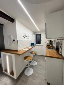 a kitchen with a counter and two stools in it at The Secret Garden in Salerno