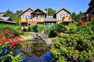 a large house with a pond in the yard at Inn at Cannon Beach in Cannon Beach