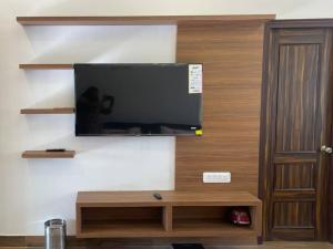 a flat screen tv on a wall in a room at Lush Green Workation Villa - 1 Bedroom in Lucknow