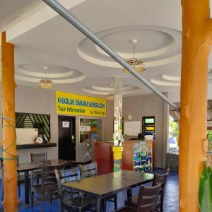 a dining room with tables and chairs in a restaurant at Khaolak Banana Bungalow in Khao Lak