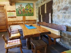 a wooden table and chairs in a room at Kandaphery Guest Houses in Miykovtsi