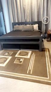 a bed in a room with a bed frame and curtains at Pisano Luxury Apartments in Lusaka