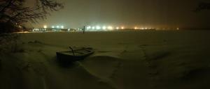 a boat sitting in the snow at night at Villa Win in Lappeenranta