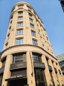 a tall building with a sign on it at LE SEOUL HOTEL in Seoul