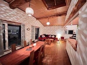 a living room with a wooden table and a couch at AnYa Ski in & Ski out at Pippu Hokkaido Max 6 ppl in Pippu