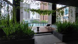 a room with a view of a pool in a building at Anggun Presidential Suites in Kuala Lumpur
