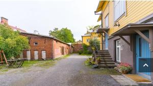 an empty alleyway between two buildings in a town at Fabia in Turku