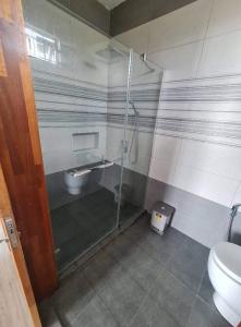 a bathroom with a shower and a toilet at Silverwood in Pereybere