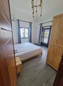 a bedroom with a bed and two windows at Silverwood in Pereybere