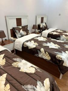 a bedroom with two beds with brown and white blankets at شقة متكاملة غرفتين مع جاكوزي in Riyadh