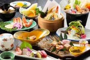 a group of plates of food on a table at Tsutaya Ryokan in Toyooka