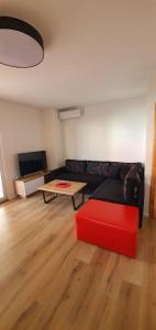 a living room with a red couch and a table at Apartman Lejla in Orebić